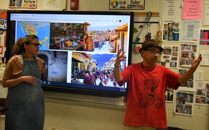 Megan Broome/The Clayton Tribune. Artist Javier Silverio, director of Taller Leñateros in Chiapas, Mexico, speaks to classes at Rabun County High School April 21 about his inspiration behind his artwork which comes from his Mayan culture and love for the environment. Spanish teacher Scarlett Shaffer introduces the guest artist and translates. The classes joined students in art classes and Spanish classes.