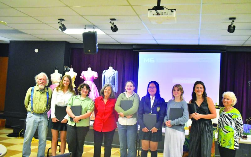 At the scholarship celebration are Dietrich Hoecht, committee member (left); Kailyn Neal; Rebekah Ramey; Penny Bradley, North Georgia Arts Guild Scholarship Program committee chair; Autumn Smith; Ruichen (Sarah) Zhang; Zoey Townsend; Abigail Carver; and Kathy Beehler, committee member.