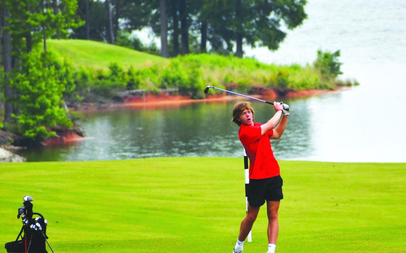 Luke Morey/The Clayton Tribune. Wildcat Charlie Cuttino watches his golf shot at Arrowpoint Pointe.