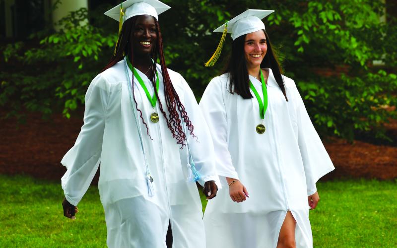 Luke Morey/The Clayton Tribune. Rabun Gap seniors Calea Jackson (left) and Emily Cox are all smiles as they process down for the graduation ceremonies on Sunday, May 21.