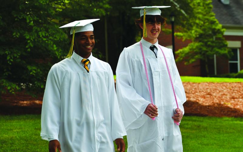 Luke Morey/The Clayton Tribune. Armani Guzman (left) and Jacob Day share a laugh as they walk down for the graduation ceremonies on Sunday, May 21. Guzman was a staple for the Rabun Gap baseball team, while Day was a consistent kicker for the Eagles football team.