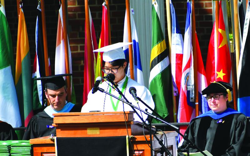 Luke Morey/The Clayton Tribune. Rabun Gap senior Jeongho Min read verses from the Bible to help begin the Rabun Gap graduation ceremonies on Monday, May 21.