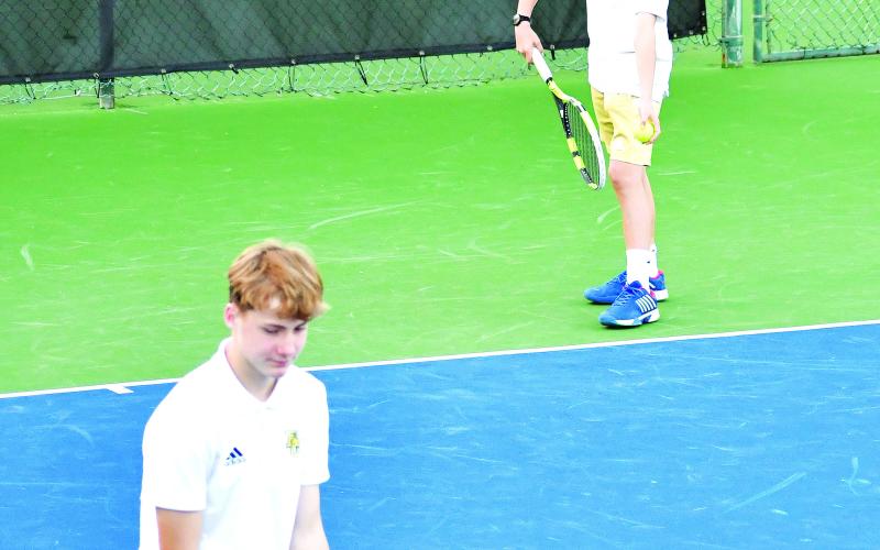 Luke Morey/The Clayton Tribune. Rabun Gap sophomore Pablo Gispert prepares to serve while sophomore tennis teammate Chris Hohmann readies at the net. The Eagles boys tennis team won 5-4 in the first round of the playoffs before losing 5-1 to Charlotte Latin School.