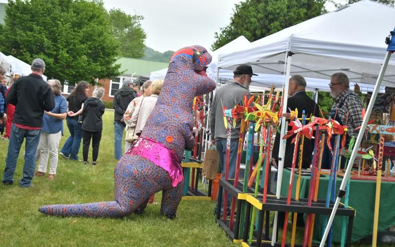 Megan Broome/The Clayton Tribune. This dinosaur made its way to Charlie Dingler and other exhibitors at Dinglerfest to check out the folk art at the inaugural festival.