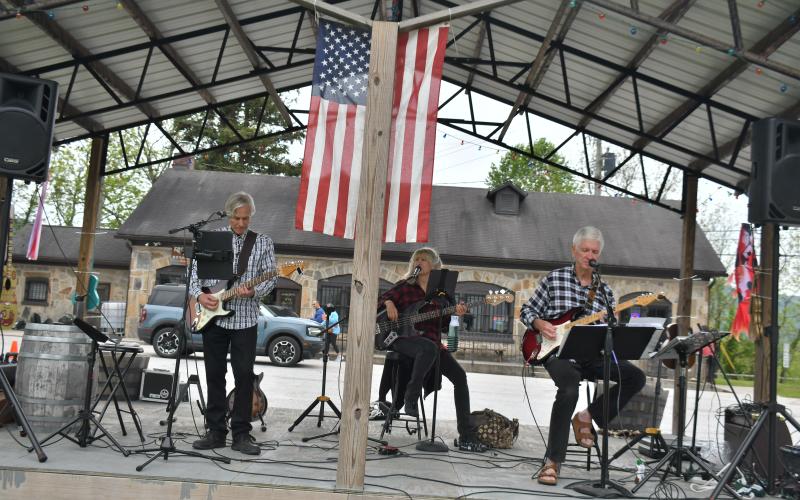 Megan Broome/The Clayton Tribune. Visitors and exhibitors at Dinglerfest in Dillard Saturday, May 6 enjoyed music by the group “Playing it Forward Trio.” The group plays 100 percent for charity, with all fees and tips benefiting Rabun County charities. Members are Karen Bacon, David Bacon and Greg Presmanes.