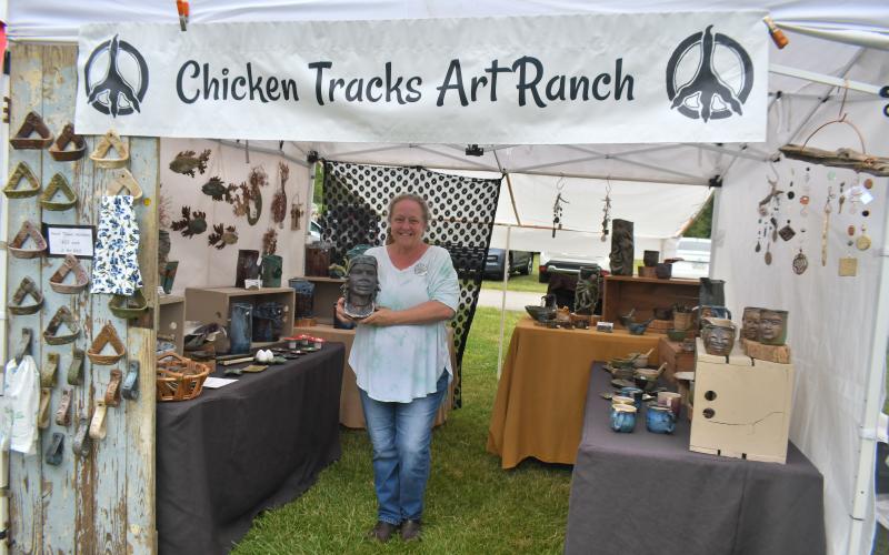 Megan Broome/The Clayton Tribune. Elizabeth Collins Hanes with Chicken Tracks Art Ranch cultivates creativity and displays her creations at Dinglerfest Saturday, May 6.
