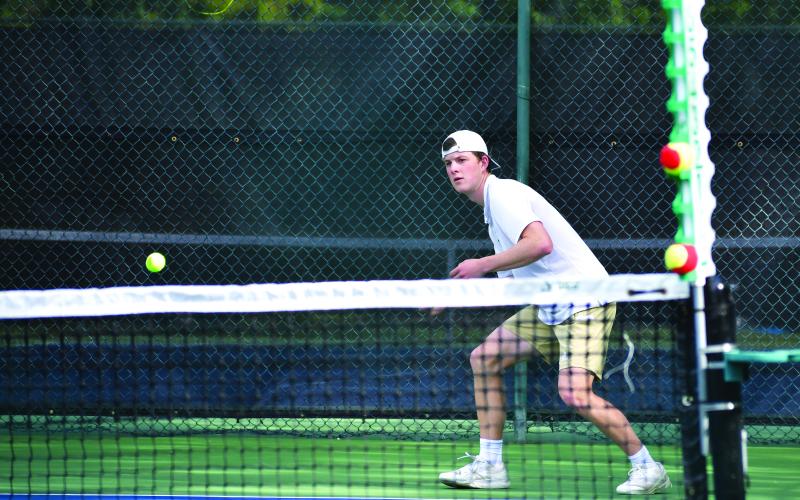 Luke Morey/The Clayton Tribune. Rabun Gap senior Dominic Vogelbacher returns a shot against Asheville Christian Academy on Thursday, May 4. Vogelbacher is one of two seniors for the Rabun Gap boys tennis team, joined by Hugo Garcia.
