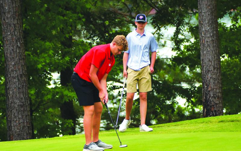 Luke Morey/The Clayton Tribune. RCHS top finisher Jack Hood lines up a putt at the state golf championship on Tuesday in Elberton.
