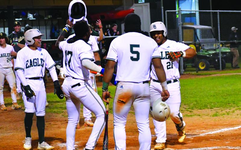 Luke Morey/The Clayton Tribune. Rabun Gap sophomore catcher Jeffrey Diaz (21) celebrates crossing the plate after hitting a grand slam that scored senior Armani Guzman (5), sophomore Denajh Williams (17) and senior Keesean Campbell (1). Diaz is leading the team with six home runs on the season.