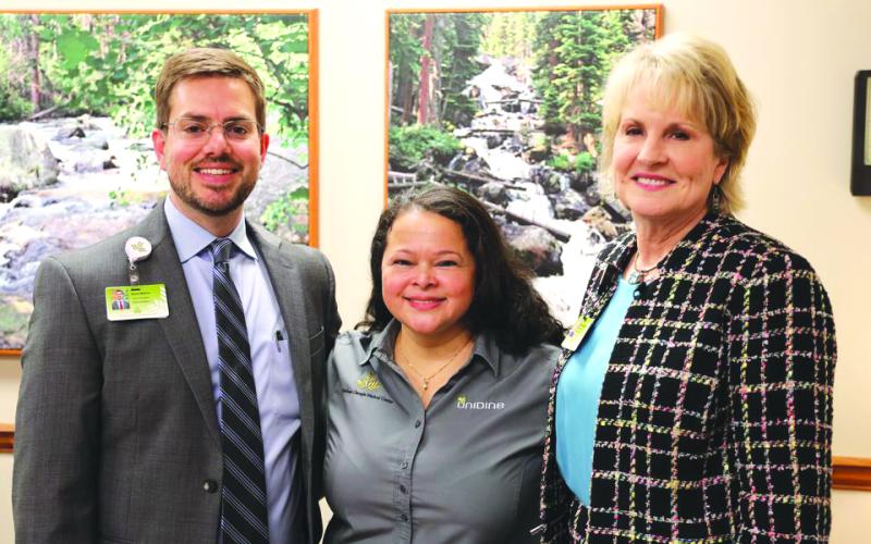 Submitted photo. Lidia Sorto has been with Northeast Georgia Health System (NGHS) for 16 years, and was named Employee of the Year for her work in nutrition services. From left are Kevin Matson, vice president of oncology, orthopedic and rehabilitation services for NGHS; Lidia Sorto, cashier with nutrition services; Carol Burrell, president &amp; CEO of NGHS.