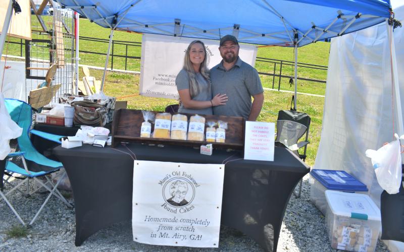 Megan Broome/The Clayton Tribune. Amber York and Jerry York with Mimi’s Old Fashioned Pound Cakes have assortments of delicious cheese cakes for sale at the Of These Mountains Spring MarketPlace.