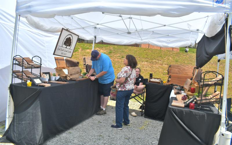Megan Broome/The Clayton Tribune. Many handmade crafts from Red Rock Wood Works owned by Drew Ekback were on display at the Of These Mountains Spring MarketPlace event Saturday, May 13.