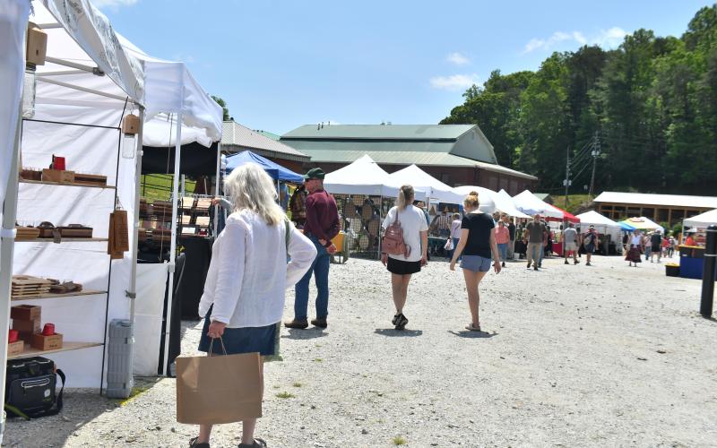 Megan Broome/The Clayton Tribune. Teresa Weiser enjoys attending the Of These Mountains Spring MarketPlace last weekend and admires the handmade works of the artisans featured at the event.