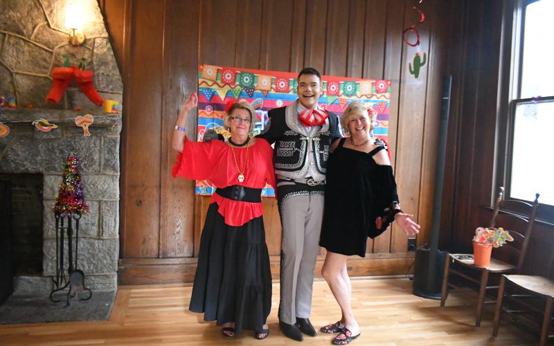 Megan Broome/The Clayton Tribune. Sharon Purdy, left, Ishmael Santos and Laura Seberg attend a Cinco de Mayo celebration organized by Rabun Entertainers at The Rock House Friday, May 5. It was also Seberg’s birthday and Rabun Entertainers along with community members sang and ate Flan for dessert after a feast with homemade tacos and all the fixings. Rabun Entertainers danced to traditional Mariachi music and sang songs in both Spanish and English.