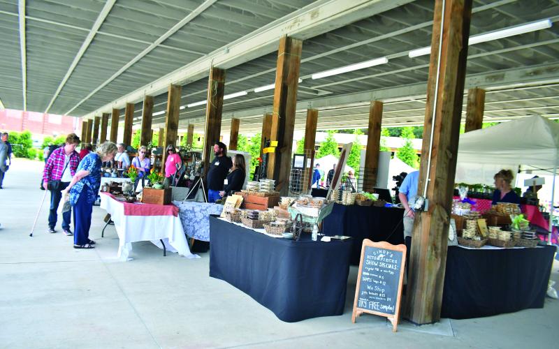 Megan Broome/The Clayton Tribune. The inaugural Sassafras Artisan Market presented by the North Georgia Arts Guild featured artists showcasing hand-made jewelry, photography, watercolor paintings, pottery, folk art, wood and metal art, fiber art, and much more. Crowds of people came out to enjoy the event April 29-30 weekend. It featured artists inside the Rabun County Civic Center and outside at the pavilions.