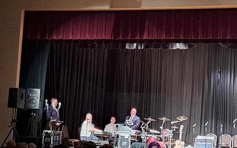 Megan Broome/The Clayton Tribune. On Saturday night, 84-year-old Mary Comb was filled with the Spirit and was welcomed on stage to sing hymns for the crowd and she received a standing ovation.