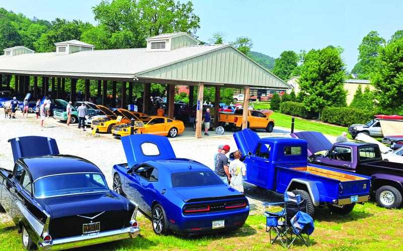 Megan Broome/The Clayton Tribune. The Inaugural "Rumble in Rabun" car and bike show featured 106 entires. Spectators locally, from around the region and surrounding states attended the event. Left: Show judge Jason Whitmire talks with Bruce Martin from Rabun Gap about his Wood Doodlebug Chevette.