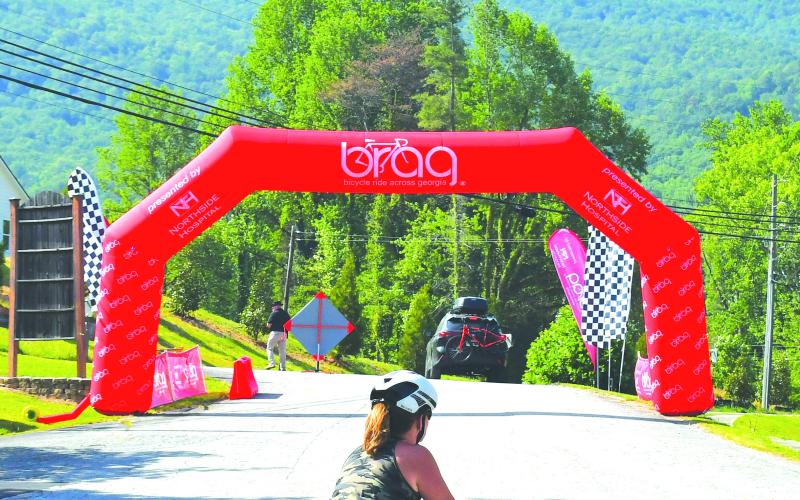 Luke Morey/The Clayton Tribune. With the BRAG start point in the background, a rider prepares for the 400-mile trek on Saturday afternoon.