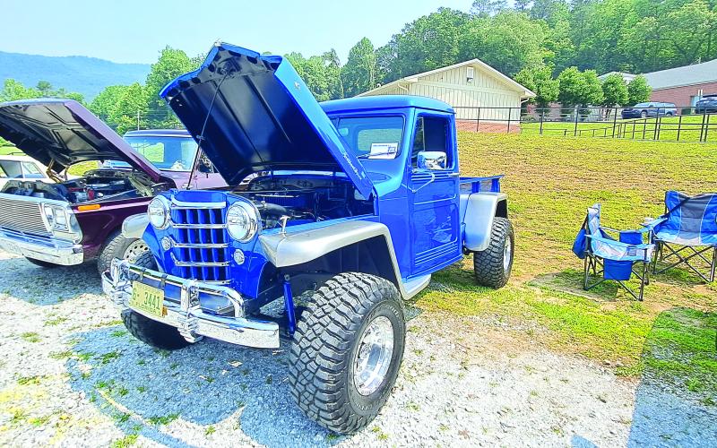 Megan Broome/The Clayton Tribune. This 1951 Jeep Willys owned by Gary Baker took home the award for Best Jeep during the show. Left: Show judge Jason Whitmire talks with Bruce Martin from Rabun Gap about his Wood Doodlebug Chevette.