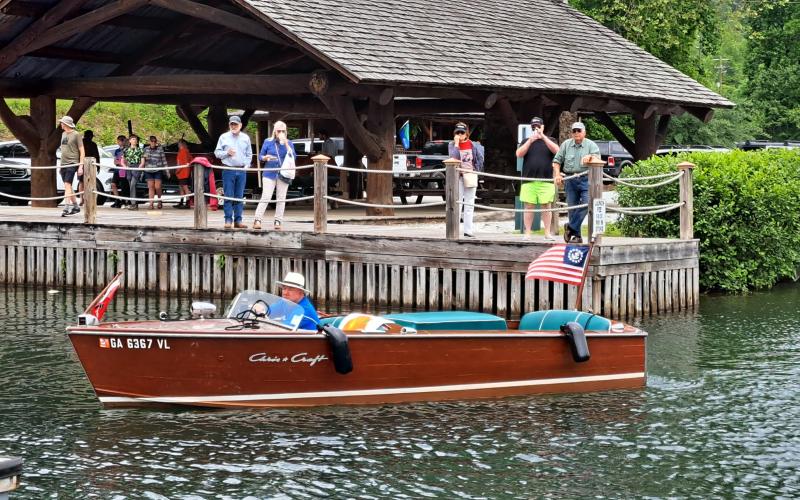 Megan Broome/The Clayton Tribune. A closeup of one of the 32 wooden boats that set sail on Lake Burton Sunday, May 28.