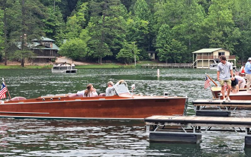 Megan Broome/The Clayton Tribune. A closeup of one of the 32 wooden boats that set sail on Lake Burton Sunday, May 28.