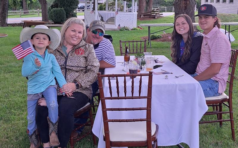 Megan Broome/The Clayton Tribune. Marcy Burdette, Erica Burdette, River Burdette, 5, Lexey Burdette and Josh Bell enjoy Memorial Day festivities on The Dillard House Oaklawn May 28.