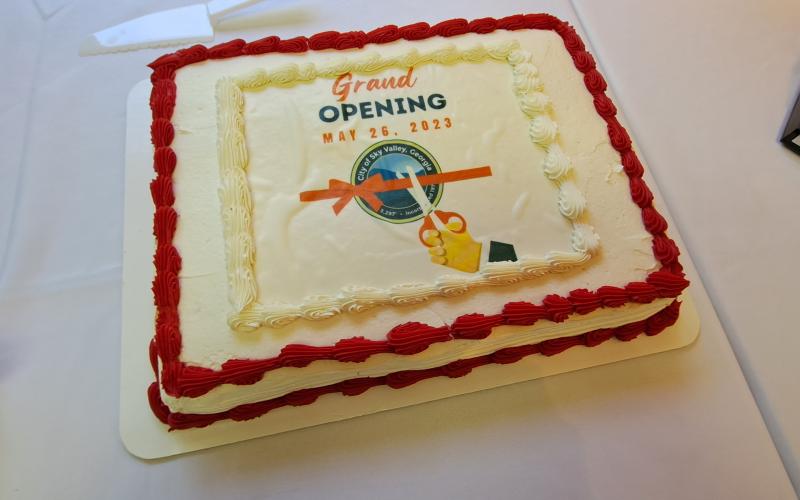 Megan Broome/The Clayton Tribune. Visitors to Sky Valley enjoyed choices of chocolate and vanilla cake at the Sky Valley City Hall ribbon cutting Friday, May 26.