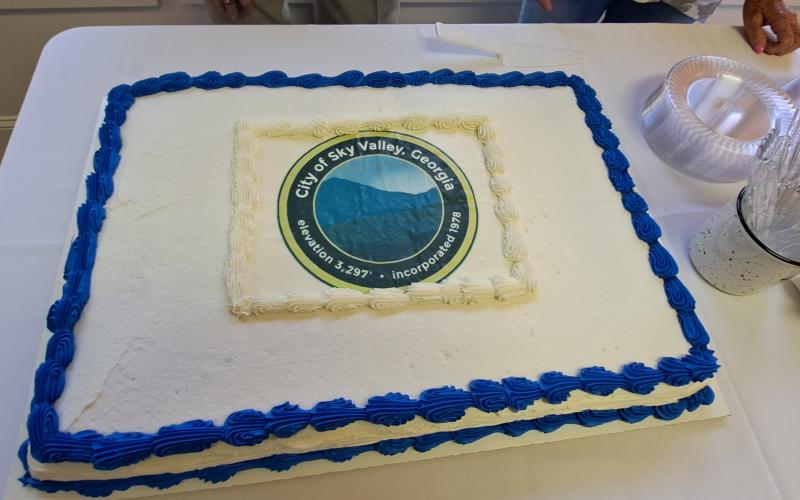 Megan Broome/The Clayton Tribune. Visitors to Sky Valley enjoyed choices of chocolate and vanilla cake at the Sky Valley City Hall ribbon cutting Friday, May 26.