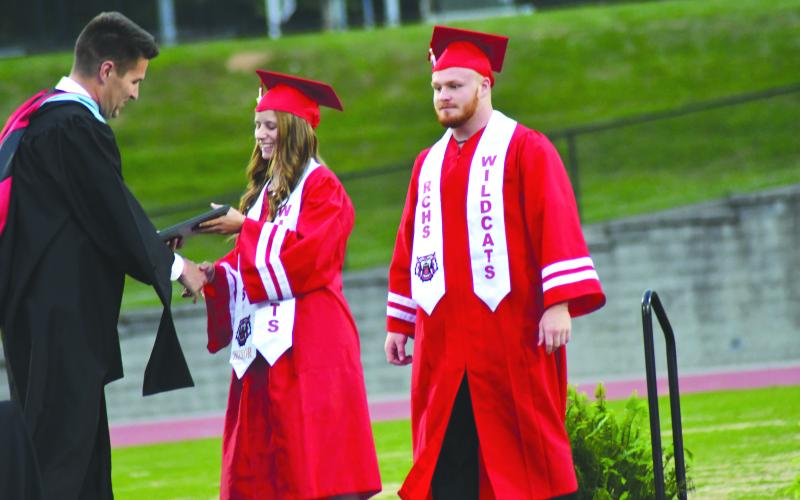 Enoch Autry/The Clayton Tribune. Rainny Ramey and Jet Galbreath  receive the “Wildcat Pride Award” from RCHS Principal Justin Spillers.