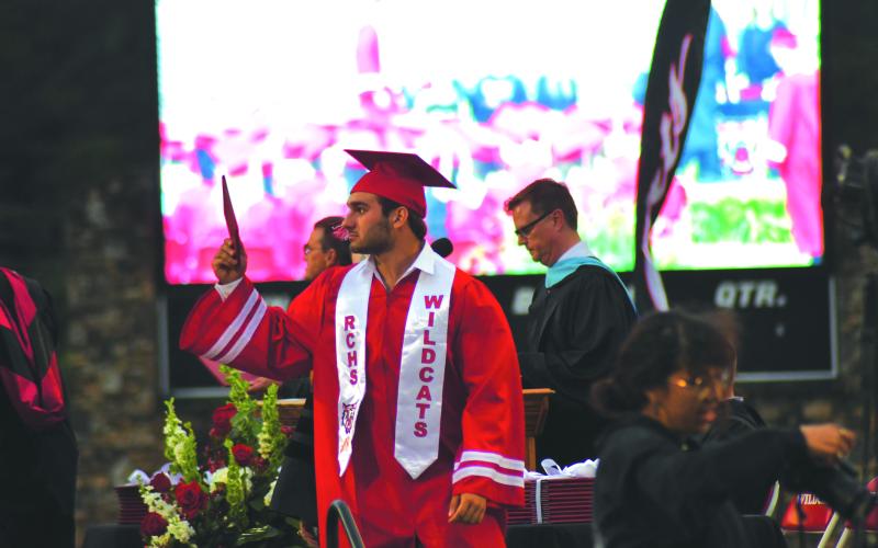 Enoch Autry/The Clayton Tribune. Nic Baloga shows his diploma to the home side of the stadium on May 26 during the graduation ceremony.