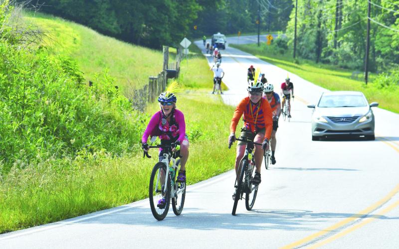 Enoch Autry/The Clayton Tribune. Jean and Bobby Bonds of Dallas, Texas, display their spikey-looking helmets as they ride in the June 4 BRAG event in Rabun County.