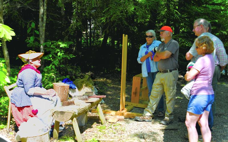 Enoch Autry/The Clayton Tribune/Carol Salloum talks with the guests at the annual Heritage Days event. Left: Enoch Autry/The Clayton Tribune. Sisters Anna, 7, and Claire, 4, Miller play inside one of the small Foxfire structures that were built for children.