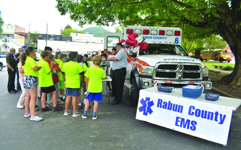 Megan Broome/The Clayton Tribune.  Rabun County EMS talks to students about the services they offer, how they help people, and gives them a look inside the ambulance. Fifth graders also got to see the stretcher and learn how it works.
