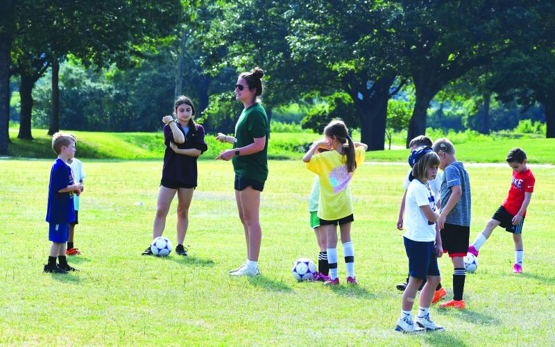 Luke Morey/The Clayton Tribune. RGNS girls soccer head coach Jesse Greener, joined by rising junior Ava Grace Bonomo, worked with her campers on passing skills. Wiese and Greener led a soccer camp with 44 local kids participating from June 5-9.