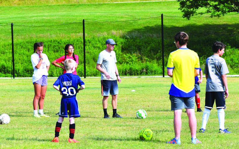 Luke Morey/The Clayton Tribune. Rabun Gap-Nacoochee boys soccer head coach Andrew Wiese talks his group of campers through the next drill.