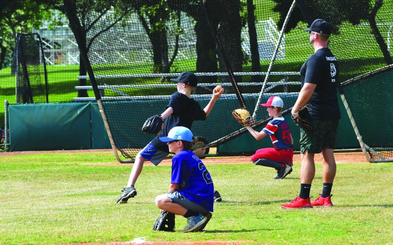 Luke Morey/The Clayton Tribune. Rabun Gap head baseball coach Clark Wright looks on as participants of the baseball camp work on their pitching and catching skills. Wright is leading another baseball camp from Monday to Friday June 12-16.Rabun Gap is offering more than 20 camps this summer, spanning from football camps to scientific imagination camps.