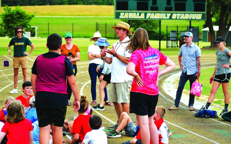 Luke Morey/The Clayton Tribune. Boys lacrosse head coach Ryne Linsley talks to the campers after the Olympics events on Friday, June 16.