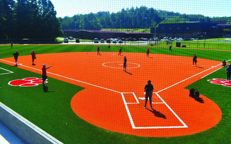 Luke Morey/The Clayton Tribune. The Rabun County High School Lady Cats practice on the newly completed turf field on Tuesday, June 27. According to head coach Wesley Satterfield, the softball team has been practicing on the turf for around four weeks now. The field includes new dugouts as well as two bullpens. The softball field is a part of a larger project that includes installing turf on the football and baseball field, as well as a new track around the football field.