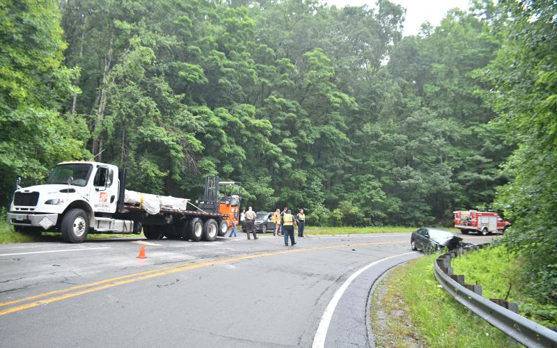 Megan Broome/The Clayton Tribune. Emergency personnel work the scene of a two-vehicle crash on Highway 76 June 19. Possible injuries were reported with no transports to area medical facilities.
