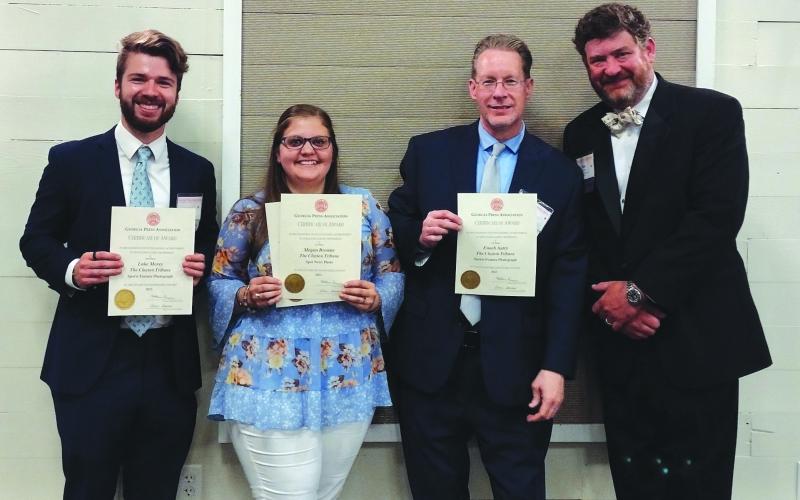 Photo courtesy Conner Horn. Holding their Georgia Press Association awards, The Clayton Tribune staff members Luke Morey, Megan Broome and Enoch Autry stand next to Community Newspapers, Inc., Chairman Alan NeSmith on June 9.