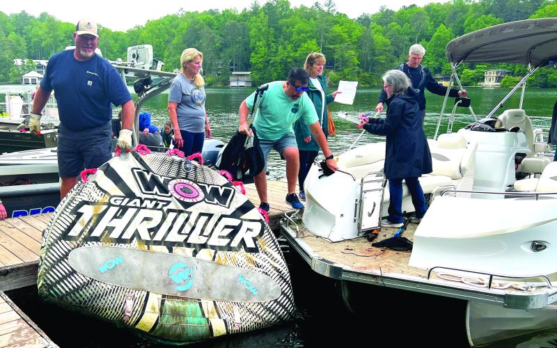Submitted photo. Volunteers for the LBCA “Clean Up the Lake Day’ event on Friday, May 12, unload a large float found on Lake Burton.