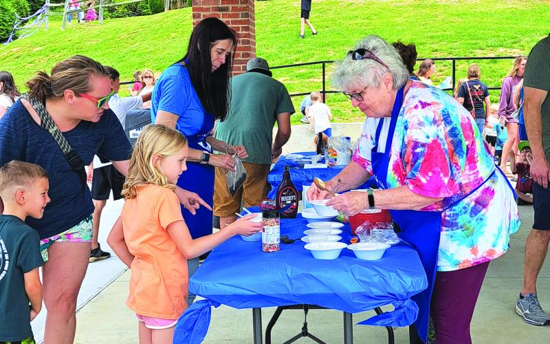 Megan Broome/The Clayton Tribune. Children enjoy an Ice Cream Sundae party at the Rabun County Public Library May 31 to kick off this year’s Summer Reading Program theme “All Together Now.”