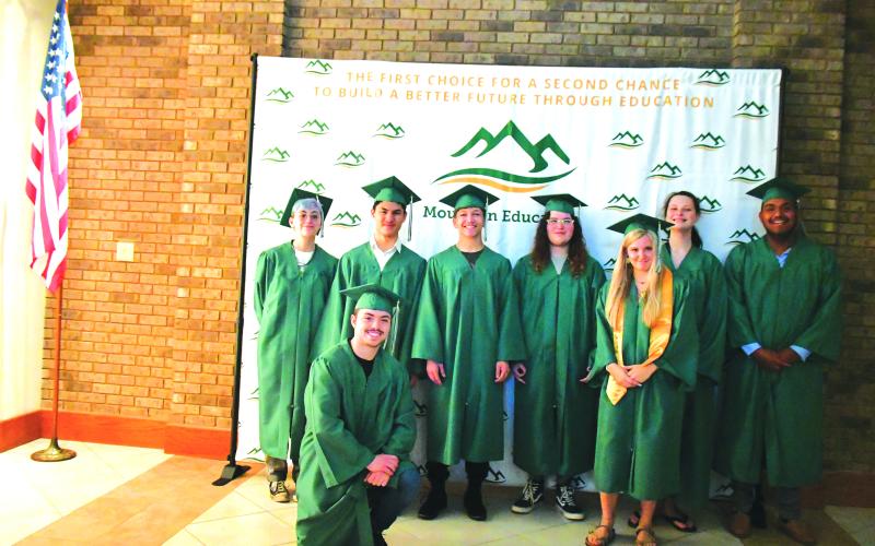 Megan Broome/The Clayton Tribune. Mountain Education Charter High School Class of 2023 graduates include Abbigail Jane Forsythe Hoy, back left; Kain Vuong Tran-Cao; Adrian Mauricio Aguilar; Bryce Cristian Weaver; High Honor Graduate Jessica Kaylee Dale; Destiny Cheyanne Jones; Fernando Silva Yepez; and Braden Daniel Edler. Not pictured is graduate Suzanna “Ana” Irene Garcia.