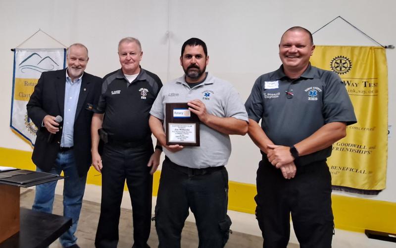 Megan Broome/The Clayton Tribune. Rabun County EMS Paramedic Jon Wilbanks is presented with the Clayton Rotary Club EMT/Paramedic of the Year award by Rotary Club of Clayton President Leif Ericson at a recent club meeting. Also pictured to celebrate Wilbanks’ accomplishments are EMS/911 Director Mike Carnes and Captain Trampes Stancil.
