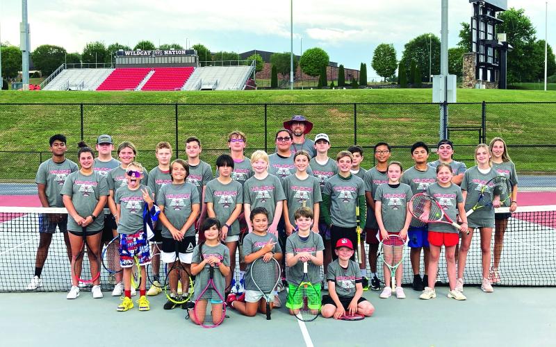 Photo courtesy Bryan Getty. Getty and Wildcat tennis athletes pose with their campers from the Wildcat Tennis Academy