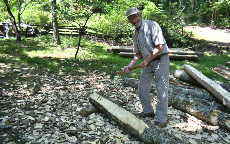 Megan Broome/The Clayton Tribune. Foxfire Museum Director Barry Stiles carries on the traditions of historic construction techniques by hewing logs as those who lived in the Appalachian Mountains over 100 years ago did. His passion for historic buildings motivates his work in preserving Appalachian Culture.