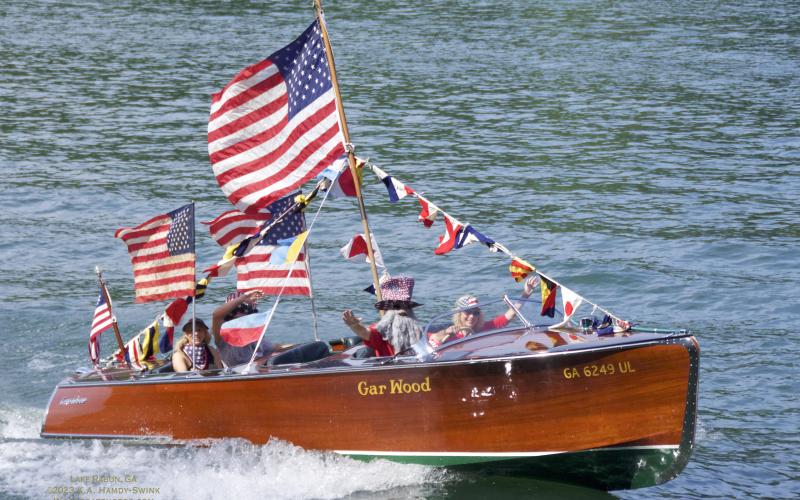 Photo courtesy KA Hamdy-Swink (WoodBoatPhotos.com). The Wooden Boat Regatta started at 10:30 a.m. on Sunday, July 2, at Big Basin on Lake Rabun as the event was led by Admiral Thad Warren. Above, owned by Dr. Charlie and Yetty Arp the GARBEAU is a 1938 Gar Wood, 22-foot Triple-cockpit Forward, Streamliner. GARBEAU is one of the last five Streamliner Gar Wood boats in existence. Two other Gar Wood Streamliners also call Lake Rabun “home.”