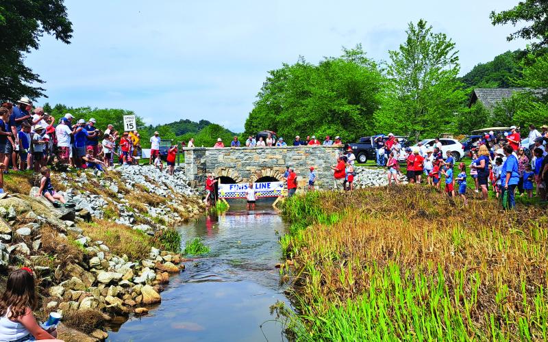 Megan Broome/The Clayton Tribune. Onlookers cheer on rubber ducks as they reach the finish line of the “Georgia Quacker 400” in Sky Valley July 3. 6-month-old Emerson Brock took home First Place with duck number 47 and 5-year-old Kendall Munoz took home Second Place with duck number 118.