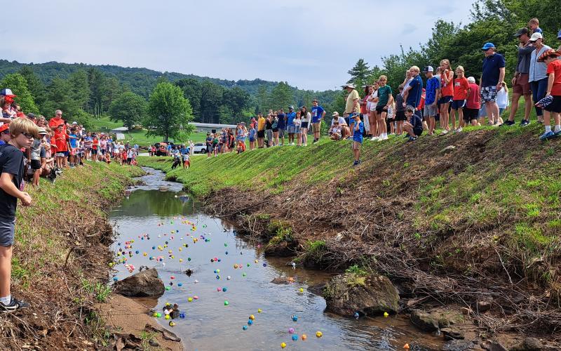 Megan Broome/The Clayton Tribune. Hundreds of people watched as rubber ducks lined up for the “Georgia Quacker 400” race in Sky Valley July 3.