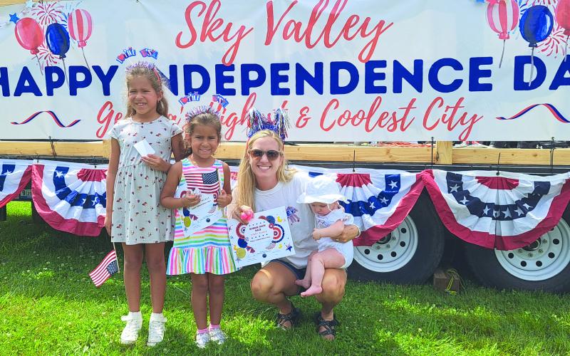 Six-month-old Emerson Brock, right, was the winner with duck number 47 in the “Georgia Quacker 400” rubber duck race in Sky Valley July 3. Pictured holding Emerson is Dadney Brock. The family was featured in the parade and is fourth-generation, with this year as the 50th year of attending the parade. Great-grandparents are Bruce and Jane Kyburz of Sky Valley. Pictured in the center is Kendall Munoz, 5, who took Second Place in the  “Georgia Quaker 400” rubber duck race with number 118 and Chelsea Munoz, 7.